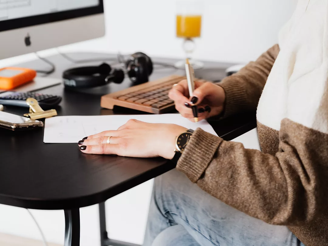 Photo of someone signing a Contract at a desk