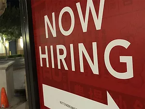 A sign reads "Now Hiring."