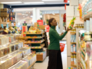 A shopper reads a food label at a grocery store. Photo: Getty.