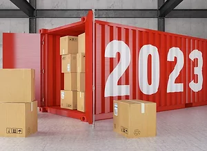 A RED SHIPPING CONTAINER WITH YELLOW 2023 NUMBERS ON ITS SIDE STANDS OPEN
