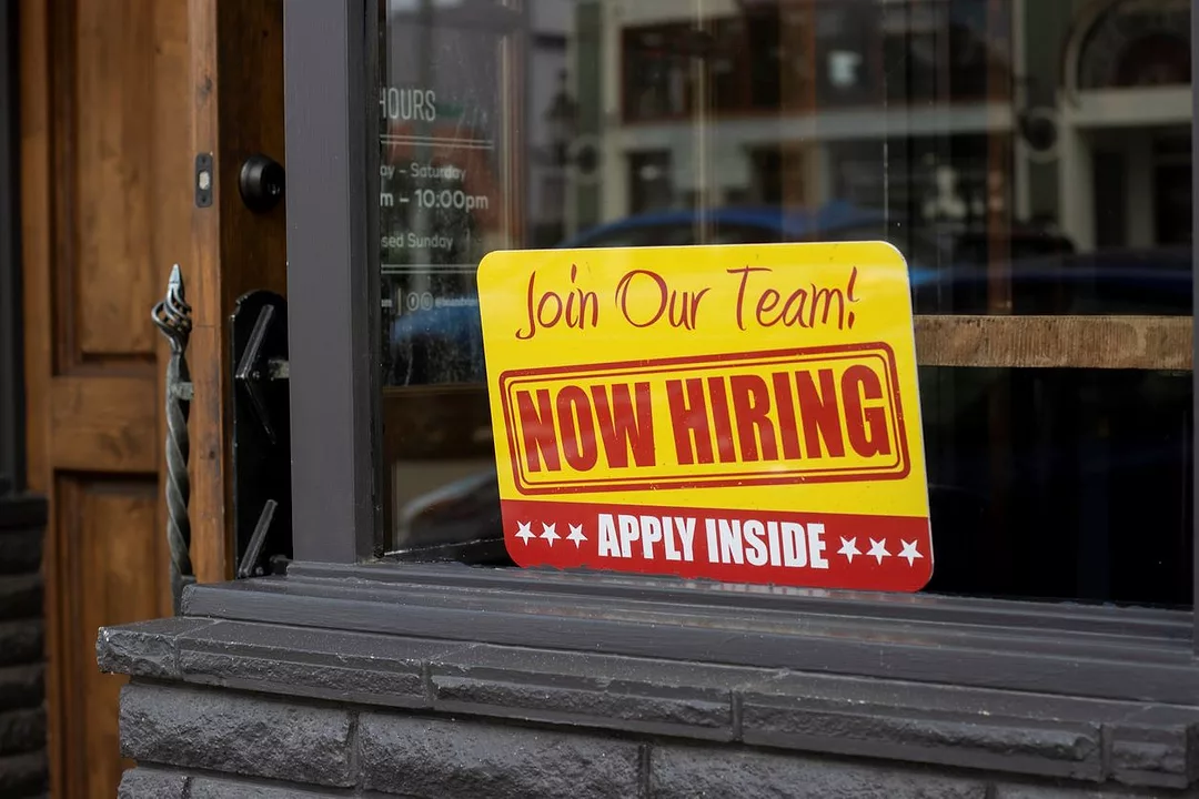 Photo of ad saying "we're hiring" in store window. Source: iStock