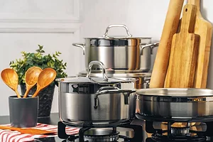 PHOTO OF COOKWARE ON A COUNTER WITH WOODEN SPOONS ISTOCK