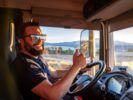 Photo of a truck driver in a truck cab giving the thumbs up. iStock-Miguel Perfectti-1352100907.jpg
