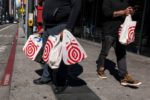 Shoppers carry Target shopping bags in front of a store in San Francisco, California, US, on Tuesday, May 10, 2022.