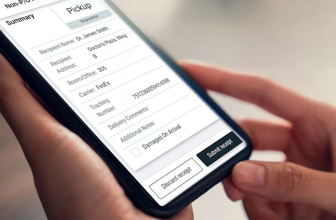 A hand holds a device showing the TECSYS hospital receiving app
