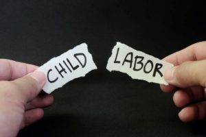 TWO HAND PULL APART PIECES OF PAPER BEARING THE WORDS CHILD AND LABOR iStock-J-ohn Kevin1402795264.jpg
