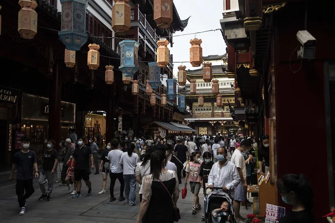 SHOPPERS IN A CROWDED STREET IN CHINA