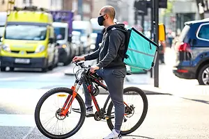 A DELIVERY PERSON ON A BICYCLE