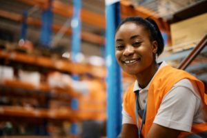 A SMILING WORKER IN A WAREHOUSE