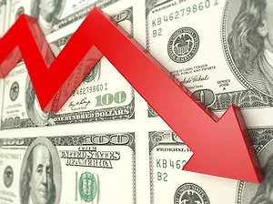 IMAGE OF EARNINGS GRAPH GOING DOWN OVER A BAKCGROUND OF DOLLAR BILLS