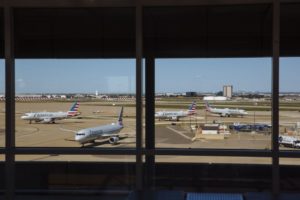 MULTIPLE AIRCRAFT SIT ON THE TARMAC AT DALLAS FORT WORTH AIRPORT