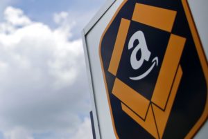 PHOTO OF AMAZON LOGO ON A GIANT SIGN AGAINST A BLUE SKY