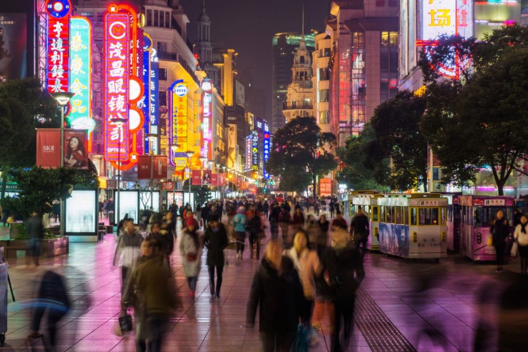 CHINA SHOPPERS ON BUSY NANJING ROAD IN SHANGHAI AT NIGHT