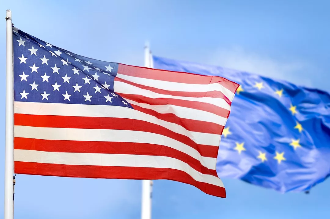 US AND EU FLAGS ON POLES FLUTTER IN A BREEZE