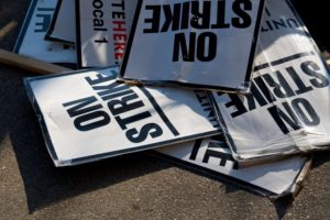 A JUMBLE OF STRIKE SIGNS LIE ON THE GROUND