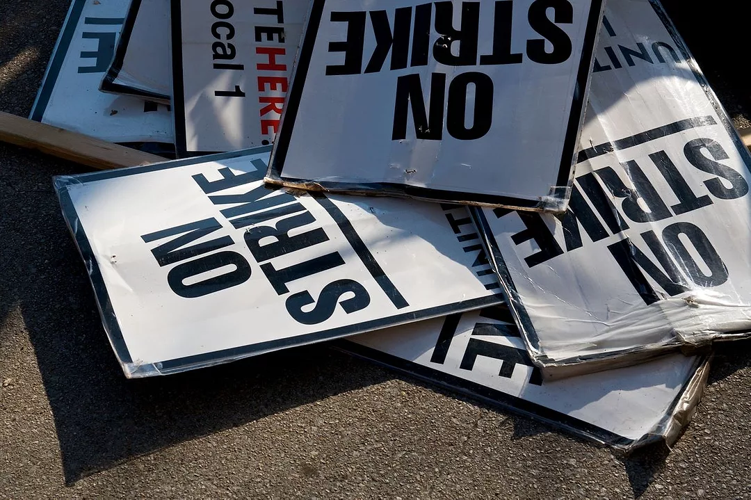 A JUMBLE OF STRIKE SIGNS LIE ON THE GROUND