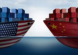 A GRAPHIC SHOWS TWO CONTAINER SHIPS FACING ONE ANOTHER, ONE BEARING AMERICAN FLAG, THE OTHER THE FLAG OF THE PEOPLE'S REPUBLIC OF CHINA