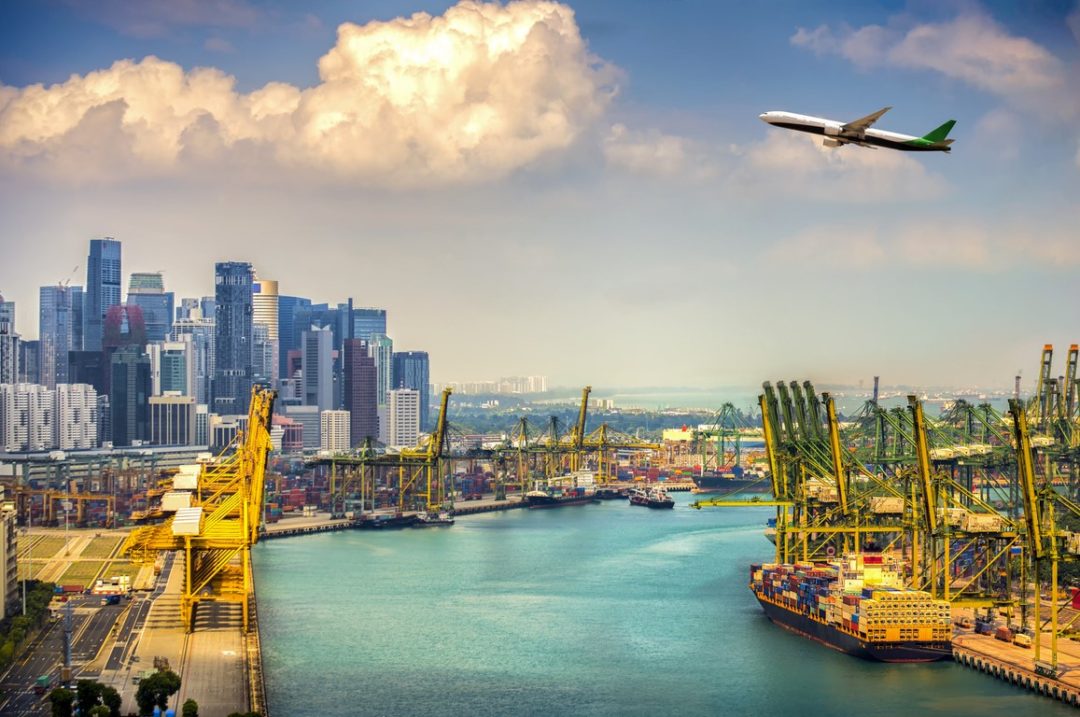 A PLANE FLIES OVER THE CITY AND PORT OF SINGAPORE