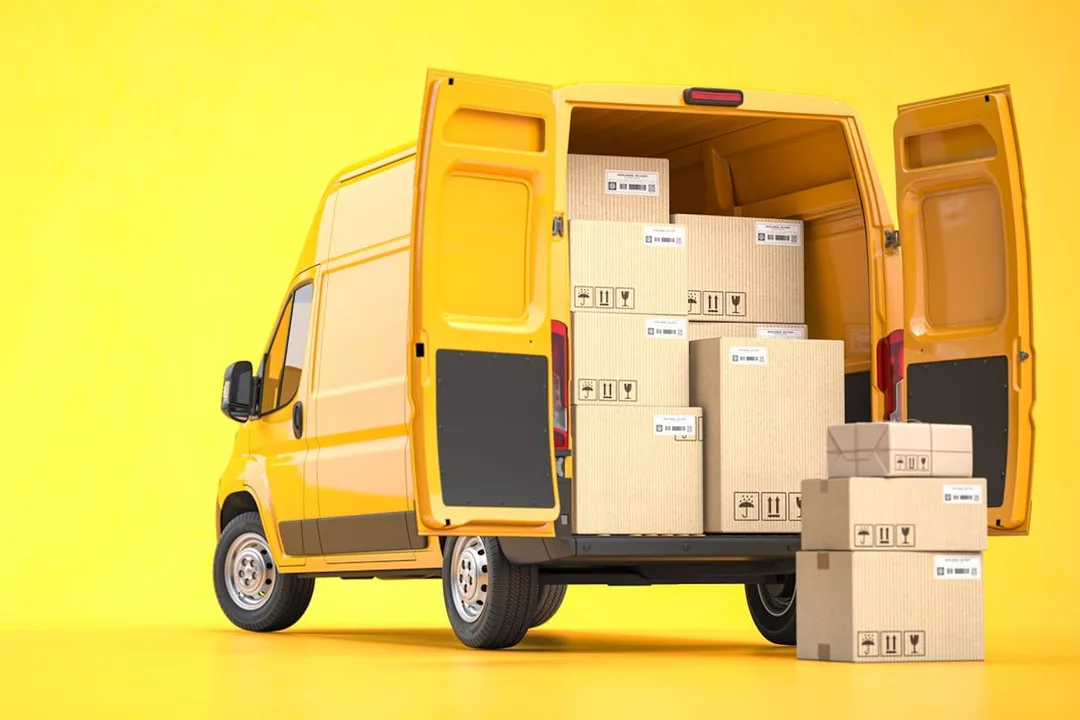 A BRIGHT YELLOW DELIVERY VAN STANDS WITH ITS DOORS OPEN, PACKAGES VISIBLE INSIDE