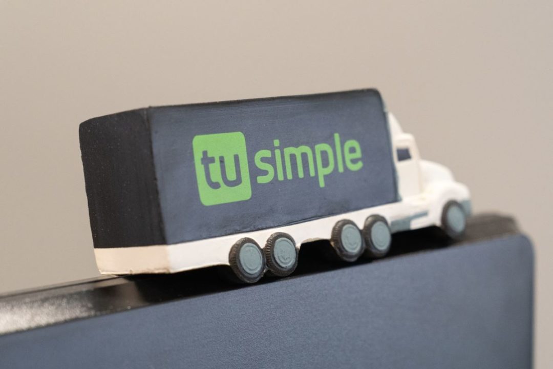 A TOY TRUCK WITH THE TUSIMPLE LOGO ON THE SIDE