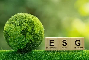 AN EARTH MODEL MADE OF GRASS SITS NEXT TO ESG LOGO 