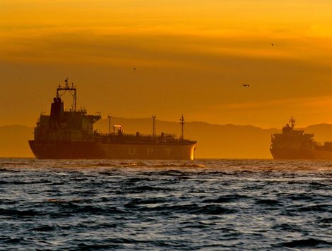 OIL TANKERS AT SEA IN THE SUNSET