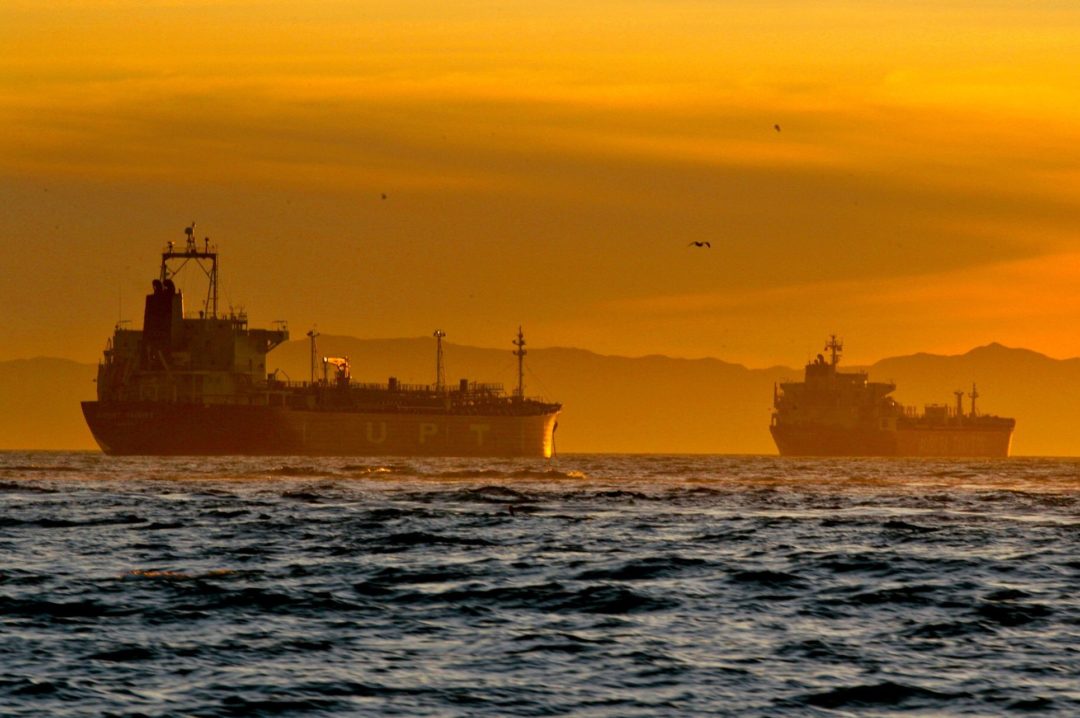 OIL TANKERS AT SEA IN THE SUNSET