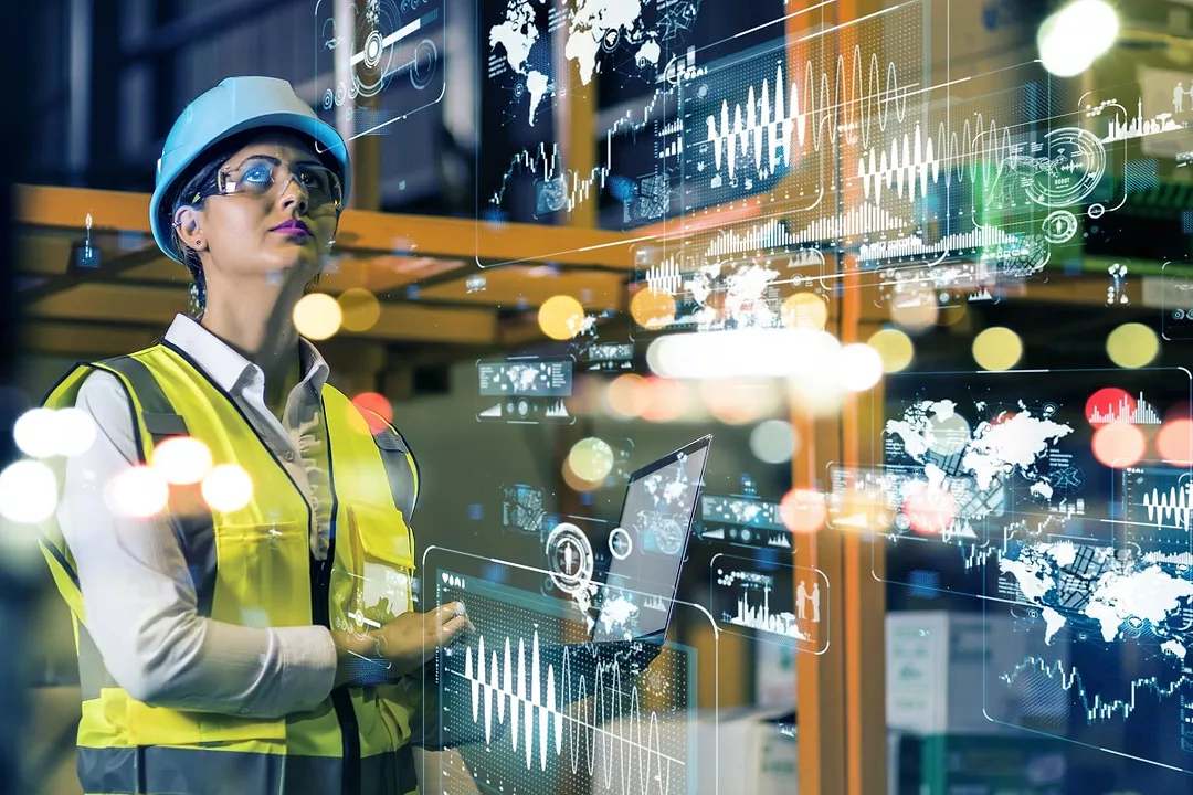 A WOMAN IN A HI-VIS VEST IS SURROUNDED BY GRAPHICS INDICATING INVENTORY DATA