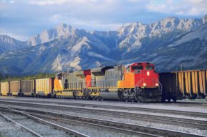 A FREIGHT TRAIN MAKES ITS WAY AGAINST A BACKDROP OF THE US ROCKY MOUNTAINSg