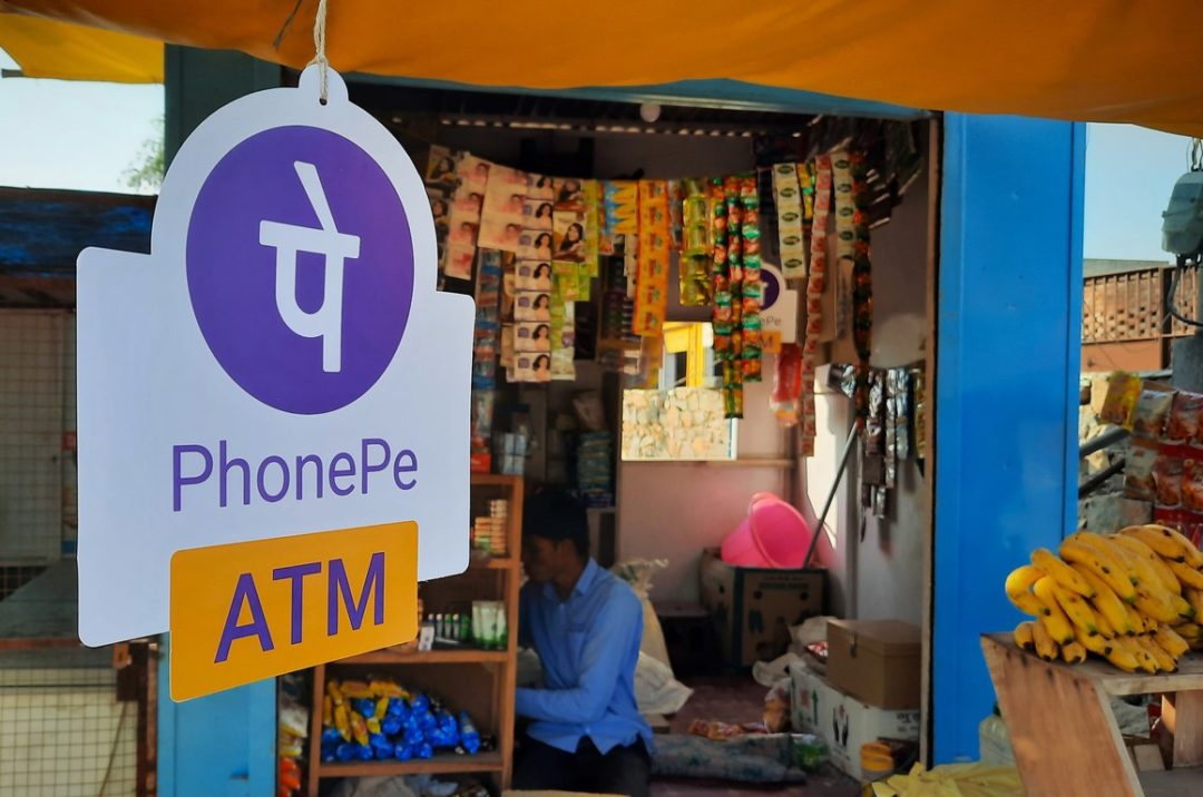 A SIGN FOR PHONEPE SITS AT THE ENTRANCE TO A SHOP