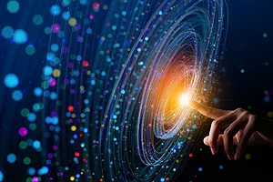 A HAND POINTS A FINGER INTO THE CENTER OF A WHORL OF COLORED LIGHTS