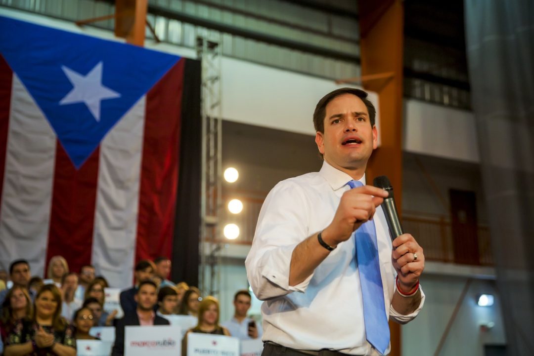 MARCO RUBIO MAKES A SPEECH IN FRONT OF A PUERTO RICAN FLAG