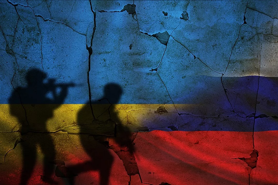 silhouette of soldiers on a cracked wall bearing the colors of the ukraine flag
