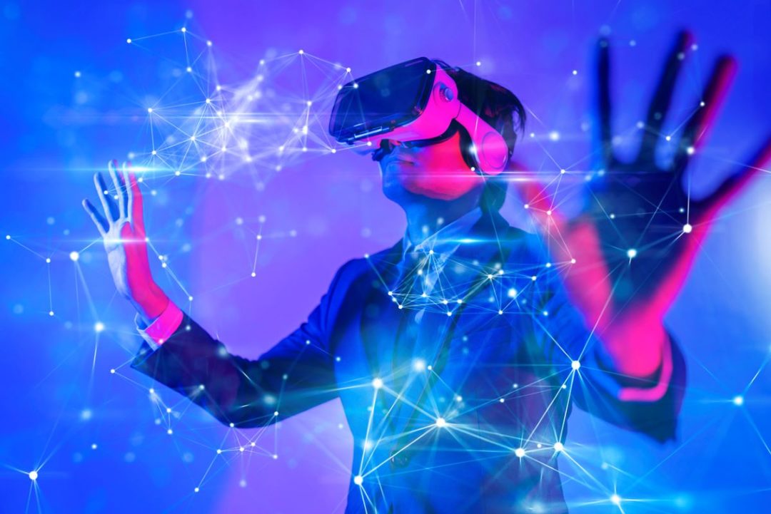 A PERSON IN A SUIT WEARING VIRTUAL REALITY GOGGLES, SURROUNDED BY LINES OF LIGHT