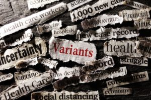 A COLLECTION OF NEWSPAPER HEADLINES CUT OUT AND ARRANGED ON A BLACK BACKGROUND, INCLUDING "VARIANTS" "1,000 NEW CASES" AND "UNCERTAINTY"