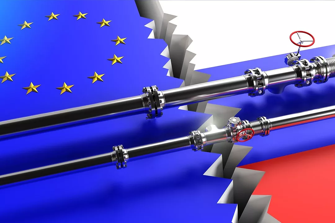 A PIPELINE CROSSES A CRACK IN CONCRETE PAINTED WITH THE EU AND RUSSIA FLAGS