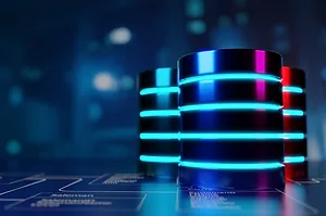 DATA STORAGE STACKS, GLOWING WITH BLUE LIGHTS, SIT ON A SHINY SURFACE