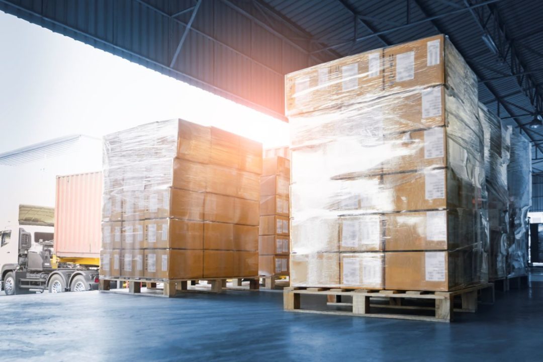 PALLETS OF CARGO SIT IN A WAREHOUSE