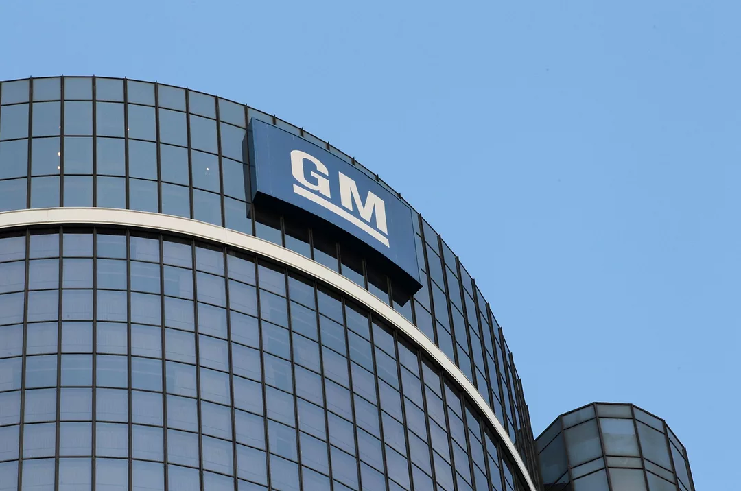 A TALL TOWER OF GLASS AND STEEL OFFICES BEARS THE GENERAL MOTORS GM LOGOpg