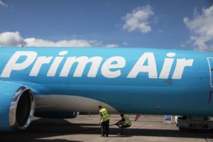 A BLUE AIRCRAFT ON THE TARMAC BEARS THE LOGO PRIME AIR IN WHITE LETTERS
