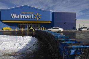 A WALMART STOREFRONT HAS SNOW IN THE PARKING LOT