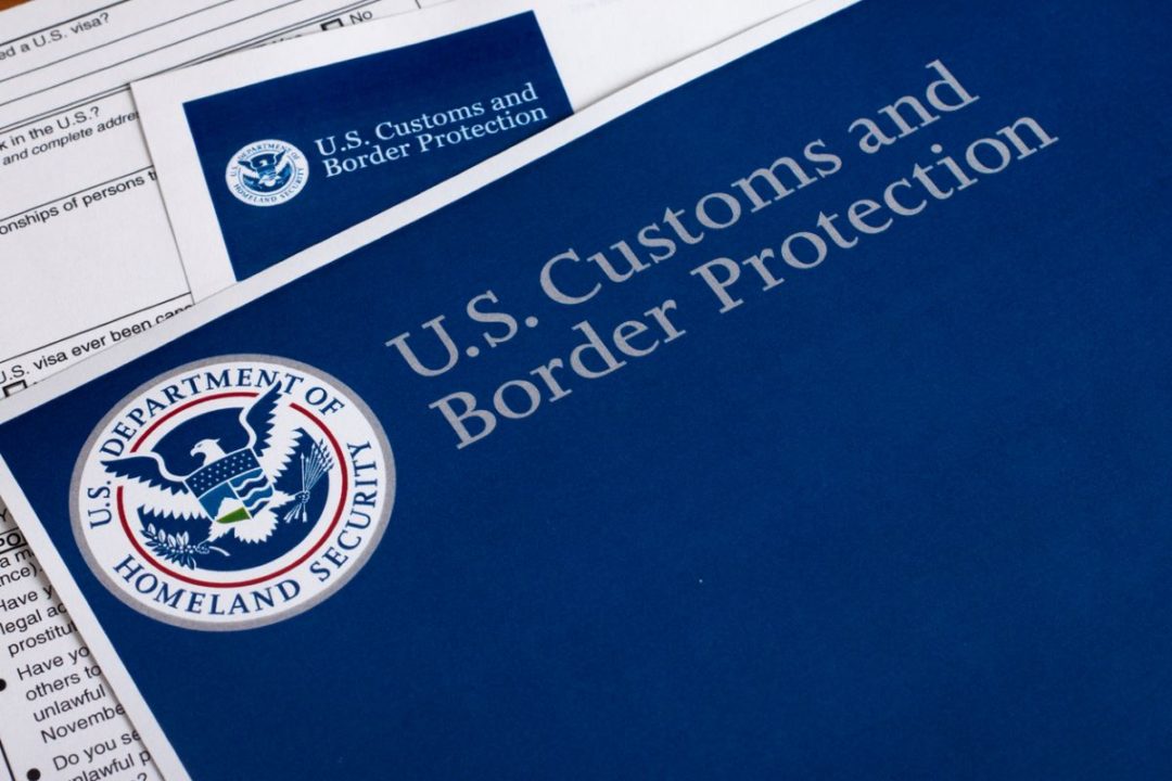 DOCUMENTS BEARING THE INSIGNIA OF US CUSTOMS AND BORDER PROTECTION LIE ON A TABLE
