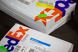 TWO FEDEX PACKAGES SIT ON A TABLE