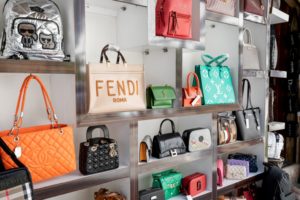 A STORE WINDOW DISPLAYS AN ARRAY OF DESIGNER PURSES