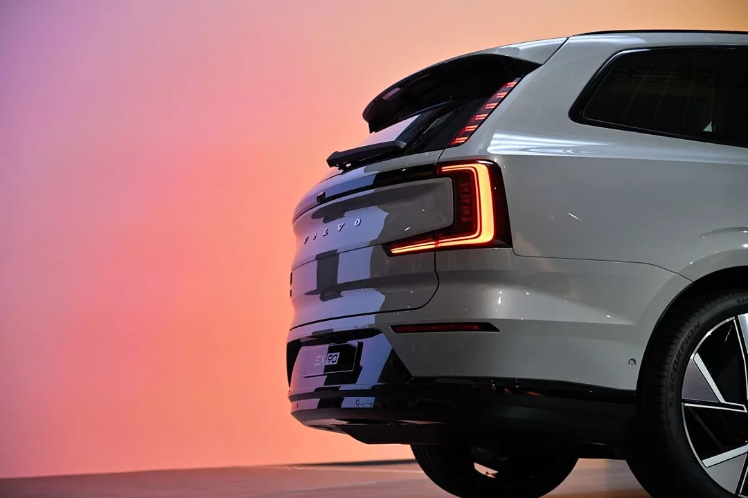 A SHINY NEW VOLVO EV SITS ON A SHOWROOM FLOOR