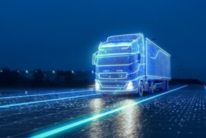 THE SHAPE OF A TRUCK DRIVING DOWN THE HIGHWAY IS PICKED OUT IN SHINING BLUE LIGHTS