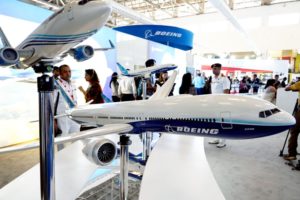 SLEEK MODEL PLANES GRACE A BOOTH AT A TRADE SHOW