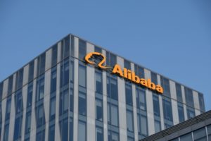 The Alibaba company logo graces a modern office building