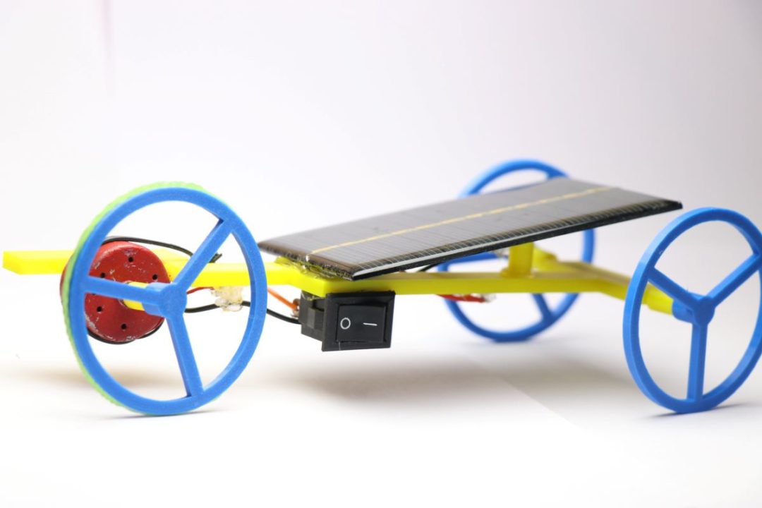 A SOLAR POWERED VEHICLE PROTOTYPE SPORTING THREE WHEELS, A FRAME, AND SOME SOLAR PANELS ONLY