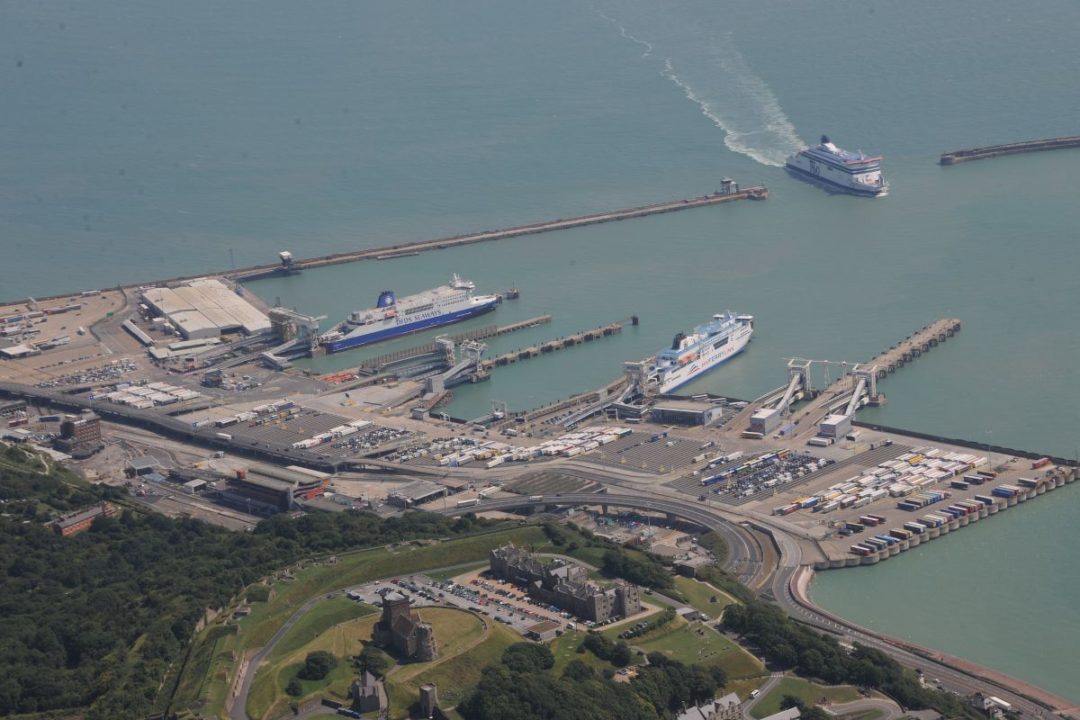 AERIAL SHOT OF PORT WITH SEVERAL FERRIES OR CRUISE SHIPS DOCKED OR APPROACHING